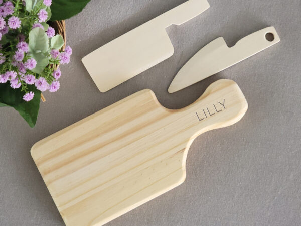 Wooden cutting board with knives for little hands